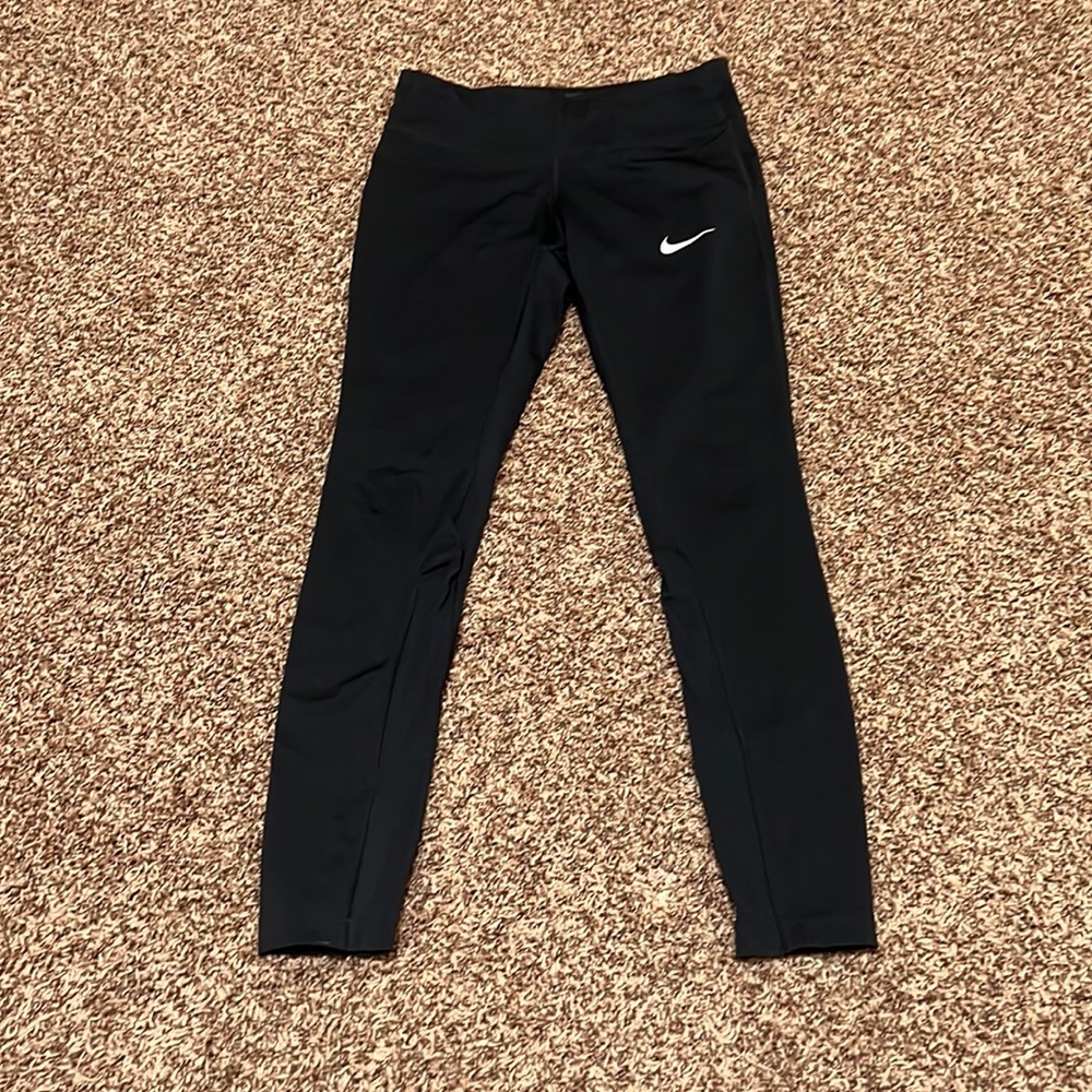 Nike Dri Fit size small black leggings. EUC. zip back pocket, mesh calf detail.